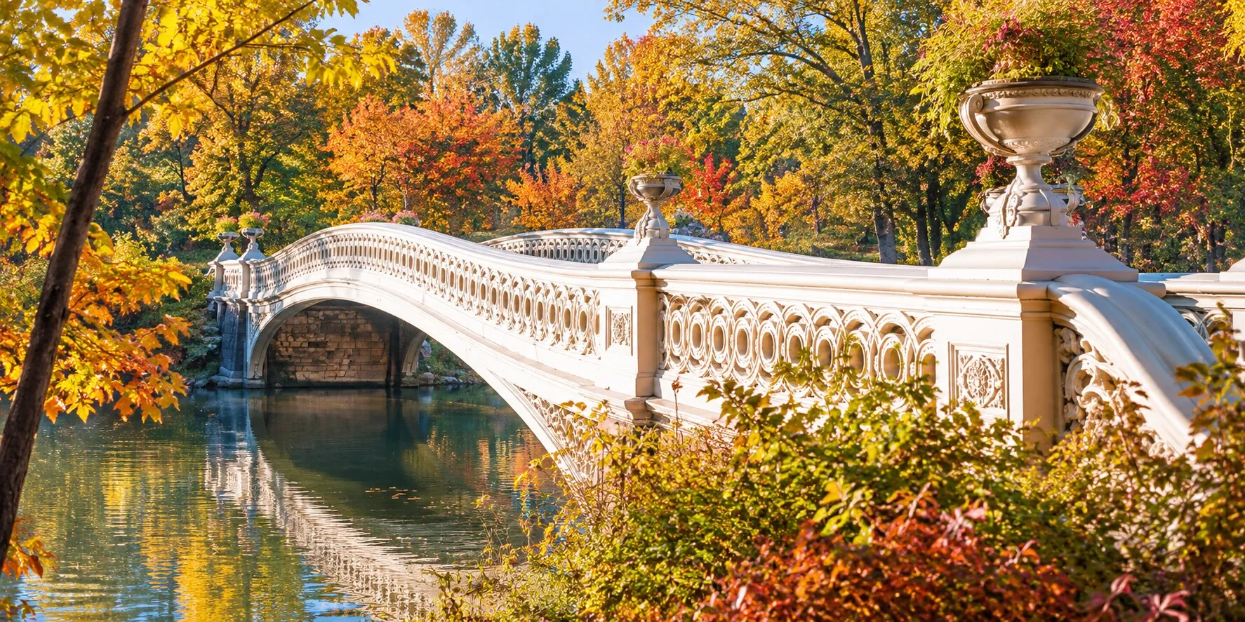Bow Bridge in Central Park surrounded by autumn foliage